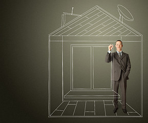 Image showing asian businessman with marker in fictional house