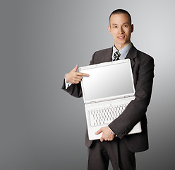 Image showing businessman with open laptop shows something