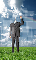 Image showing full length businessman with lamp-head push the button outdoors