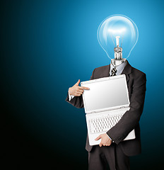 Image showing businessman with lamp-head with open laptop shows something