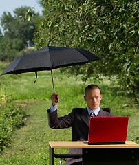 Image showing businessman with umbrella