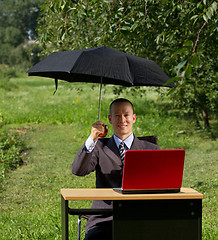 Image showing businessman with umbrella