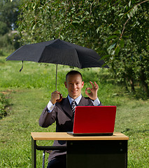 Image showing businessman with umbrella