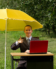 Image showing businessman with umbrella