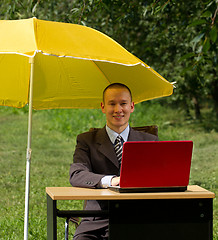 Image showing businessman with umbrella