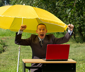 Image showing businessman with umbrella