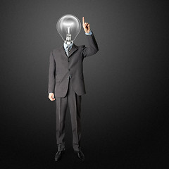 Image showing full length businessman with lamp-head push the button