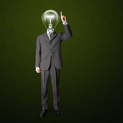 Image showing full length businessman with lamp-head push the button