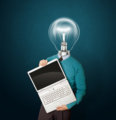 Image showing Male with lamp-head in blue with laptop