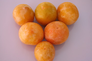 Image showing Yellow plums against lilac background