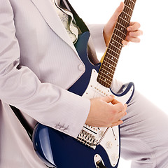 Image showing man in white suit playing guitar