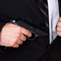 Image showing man drawing his gun from jacket pocket