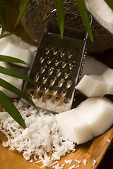 Image showing Grated coconut with grater and nut 