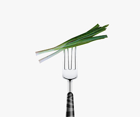 Image showing green onion pierced by fork,  isolated on white background 