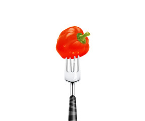Image showing Red pepper pierced by fork,  isolated on white background 