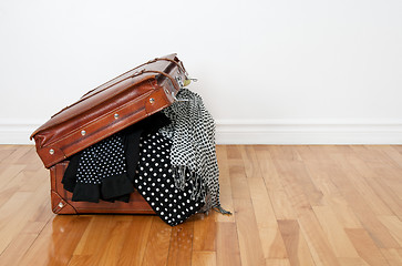 Image showing Polka dot clothing in a retro suitcase