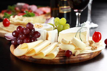 Image showing Cheese and salami platter with herbs