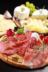 Image showing Salami and cheese platter with herbs