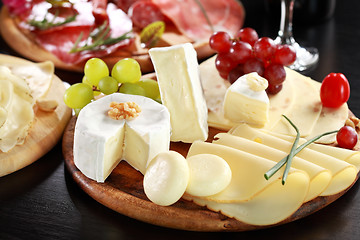 Image showing Cheese and salami platter with herbs