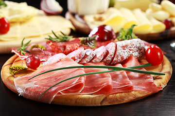 Image showing Salami and cheese platter with herbs