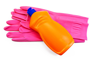 Image showing Bottle of orange with pink rubber gloves