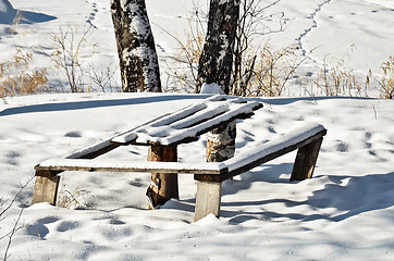 Image showing Table and bench in winter forest