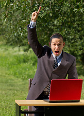 Image showing man with red laptop working outdoors