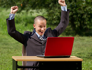 Image showing man with laptop working outdoors