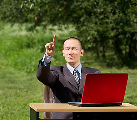 Image showing man with laptop working outdoors