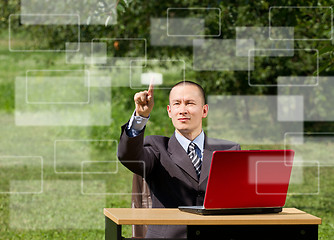 Image showing man with laptop working outdoors