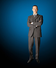 Image showing smiling standing businessman in suit 