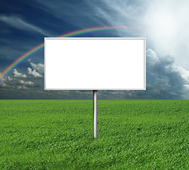 Image showing billboard and green grass and blue cloudly sky