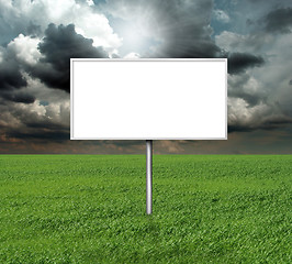 Image showing billboard and green grass and blue cloudly sky