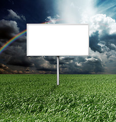 Image showing billboard and green grass and blue cloudly sky