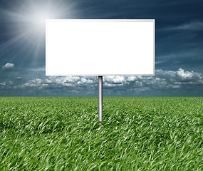 Image showing billboard and green grass and blue cloudly sky