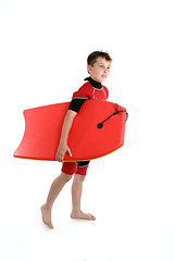 Image showing Surfer boy holding a bodyboard