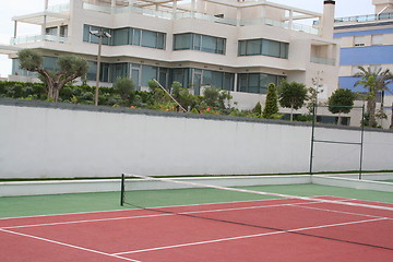 Image showing Tennis court in front of this apartment-buildings