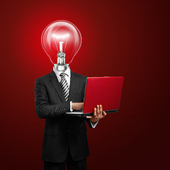 Image showing lamp head businessman with laptop