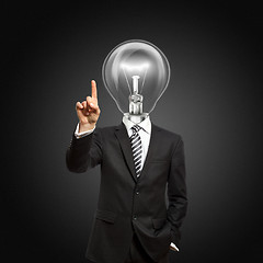 Image showing businessman with lamp-head push the button