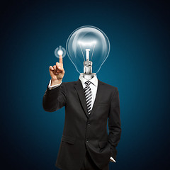 Image showing businessman with lamp-head push the button