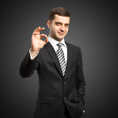 Image showing happy businessman in suit shows OK