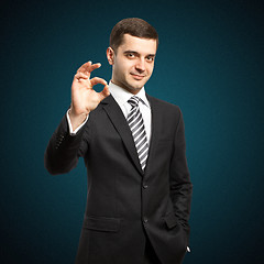 Image showing happy businessman in suit shows OK