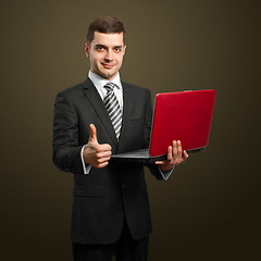 Image showing male in suit with laptop in his hands