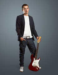 Image showing stylish man with guitar looking at camera