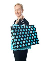 Image showing Senior woman posing with dotted shopping bag