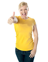 Image showing Smiling gorgeous girl showing thumbs-up