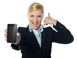 Image showing Saleswoman displaying new iphone to camera