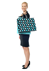 Image showing Beautiful woman standing with shopping bag