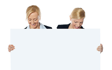 Image showing Female business executives looking at blank banner ad