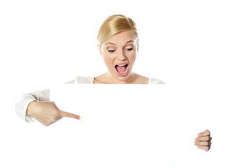 Image showing Gorgeous woman pointing at blank clipboard